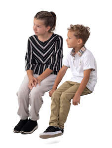 two cut out children sitting