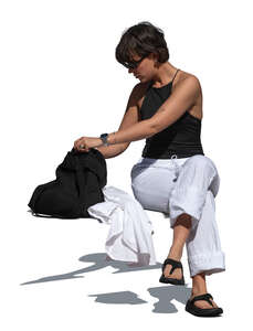 woman sitting outside and taking things from her bag
