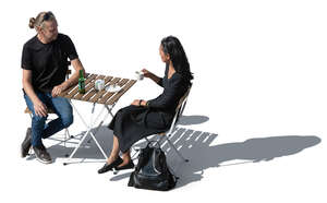 man and woman sitting and drinking coffee seen from above