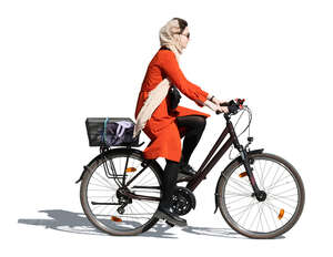 woman in a red overcoat riding a bike