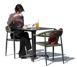 woman sitting in a cafe and reading a book