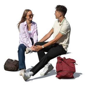 two teenagers sitting and talking