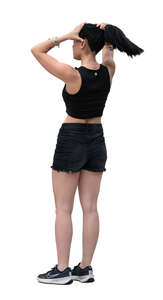 woman standing and adjusting her hair