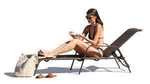 woman sunbathing and applying sun cream
