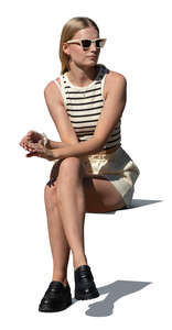 cut out woman sitting outside in the sunlight