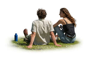 man and woman sitting on the grass side by side