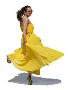cut out woman in a long yellow dress twirling and dancing