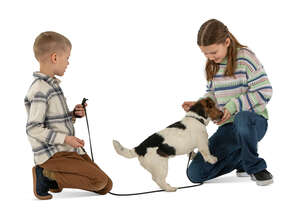 two cut out kids playing with a dog