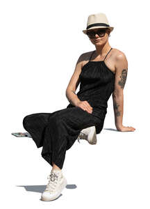 woman with a hat sitting in sunlight