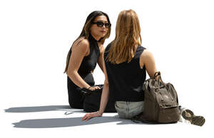 two cut out women sitting and talking