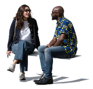 man and woman sitting outside and talking