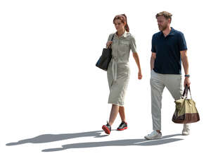 man and woman walking in backlight