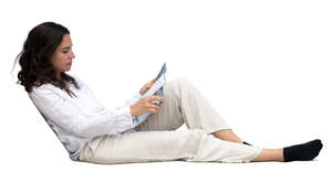woman sitting on a sofa and reading a magazine