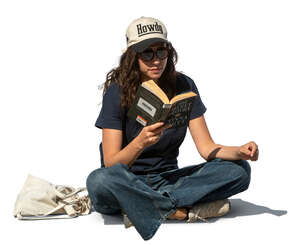 woman sitting outside and reading a book