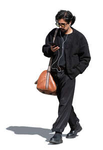 cool indian man walking and listening to music