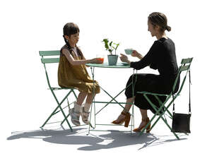 backlit scene of an asian woman and child sitting in a cafe