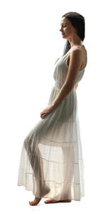 woman in a semi-sheer white dress standing in a doorway