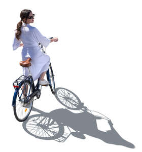 woman in a white dress riding a bike seen from above