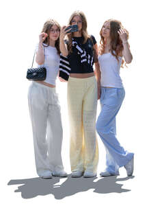 backlit group of teenage girls taking a selfie