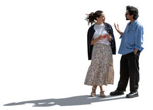 backlit man and woman standing and talking lively