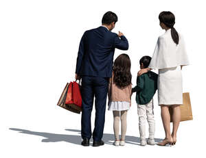 chinese family with two kids standing and looking at smth