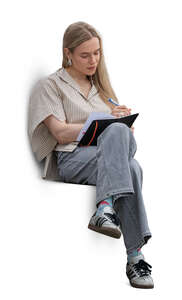 cut out woman sitting and writing in her notebook