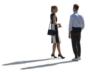 two elegant backlit people standing and talking