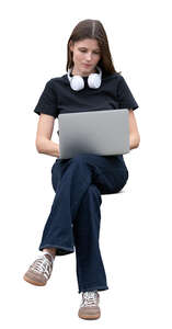 woman sitting and working with a laptop