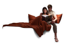 couple sitting on a sofa under a blanket and reading together