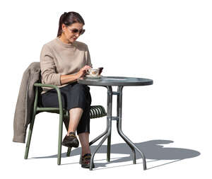 cut out woman with a phone sitting in a cafe and drinking coffee