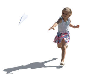 backlit girl playing with paper plane
