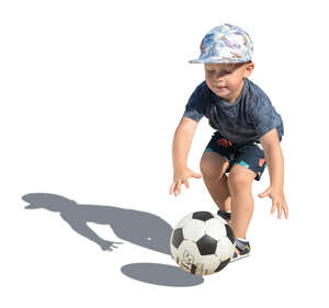 little boy playing with a football