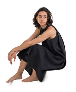 woman in a black dress sitting at home on the stairs