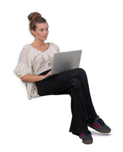 woman with a laptop sitting on a sofa