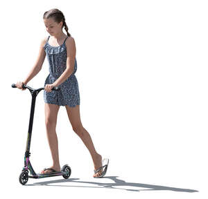 backlit girl riding a scooter in the summer