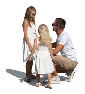 father talking to his two daughters 