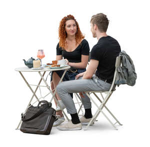 man and woman sitting in a cafe