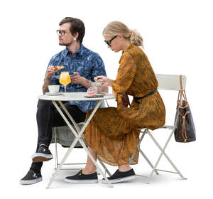 man and woman sitting in a cafe and eating