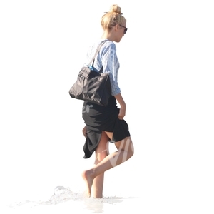 woman walking barefoot in the water