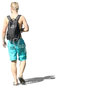 blond man in swimming pants walking