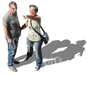 couple standing and pointing at smth