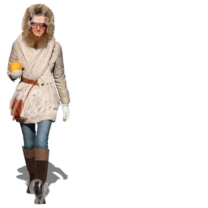 woman walking with an orange in her hand