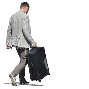 man in a suit carrying a suitcase 