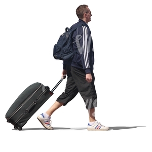 man walking and pulling a suitcase