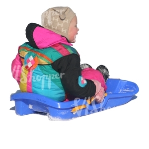 little girl sitting on a sledge