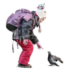 schoolgirl standing and looking at a pigeon