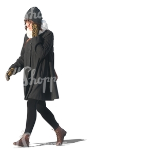 cut out woman in a black winter coat walking