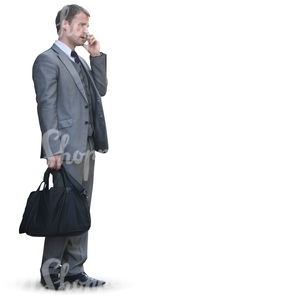 businessman with a bag standing an talking on the phone