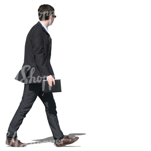 young businessman in a black suit walking