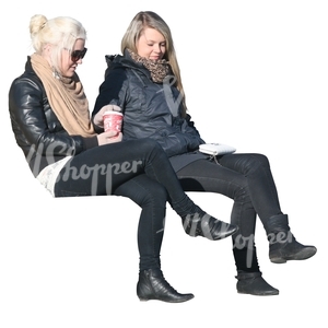 two women sitting and drinking coffee